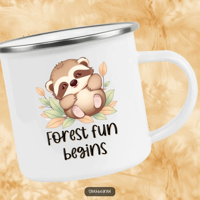 Funny enamel camping mug featuring a baby sloth bear tumbling playfully in soft leaves. A durable and humorous outdoor accessory.