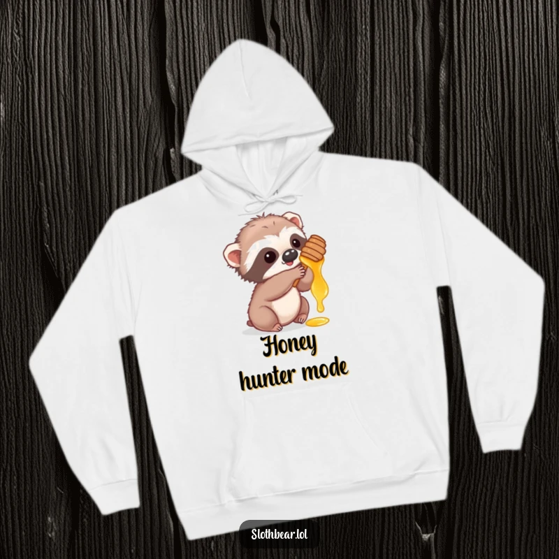 Funny hoodie with a cute sloth bear cub playfully reaching for honey, offering comfort and adorable charm.