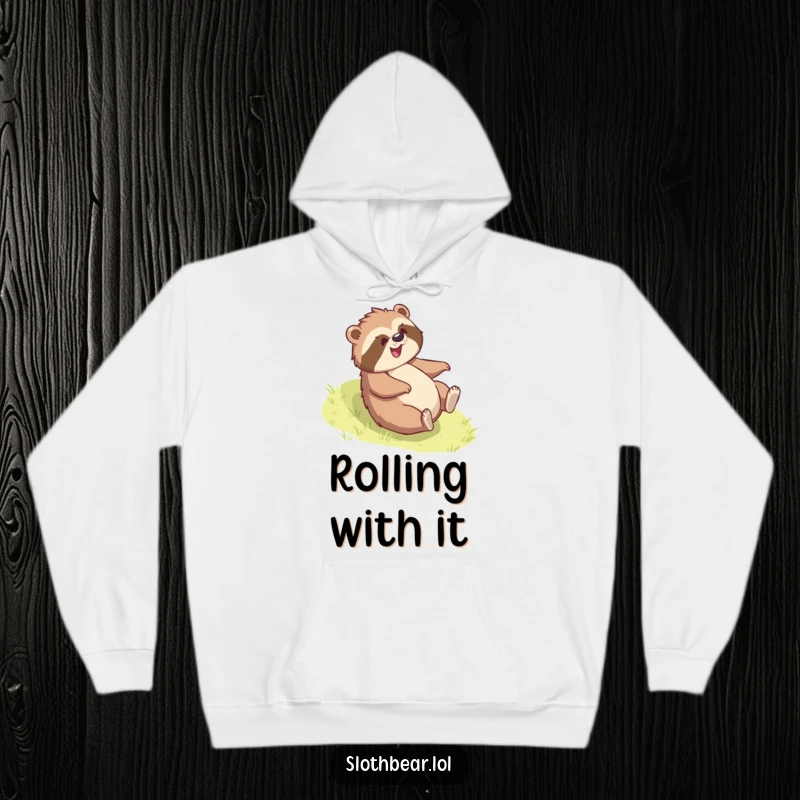 Funny sloth bear hoodie showing a bear gleefully rolling down a grassy slope, offering cozy comfort and playful humor.